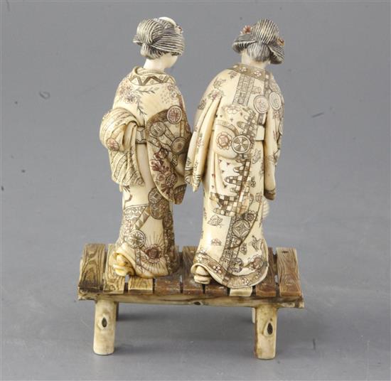 A Japanese ivory okimono of two bijin, first half 20th century, height 15cm